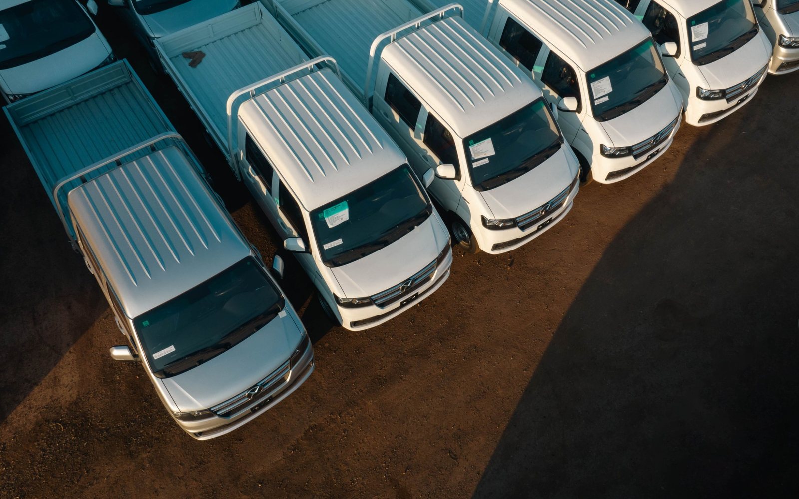 A row of commercial work vans and trucks.